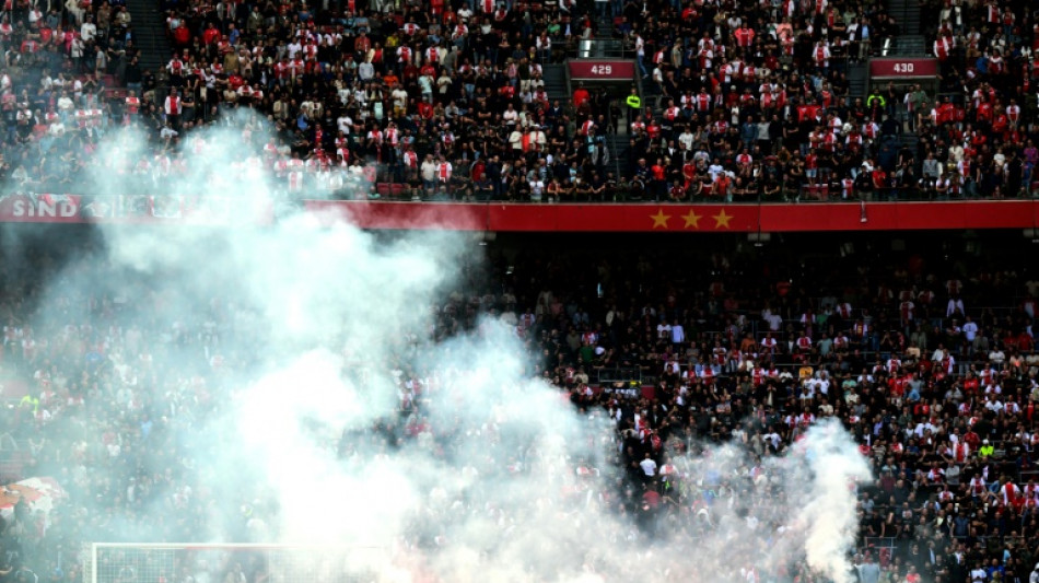 Ajax-Feyenoord scrapped after flares thrown on pitch, violence erupts